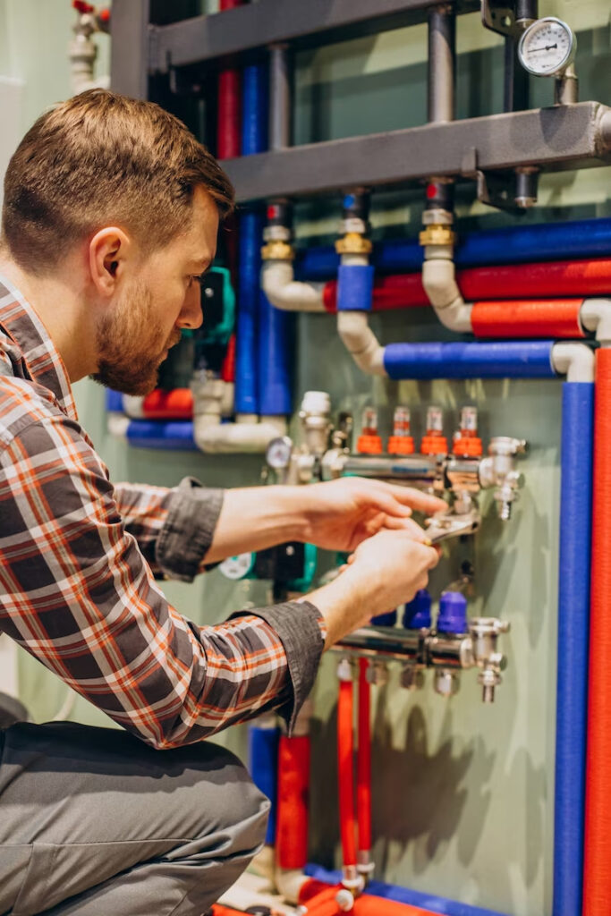 young engineer adjusting autonomous heating, heating services