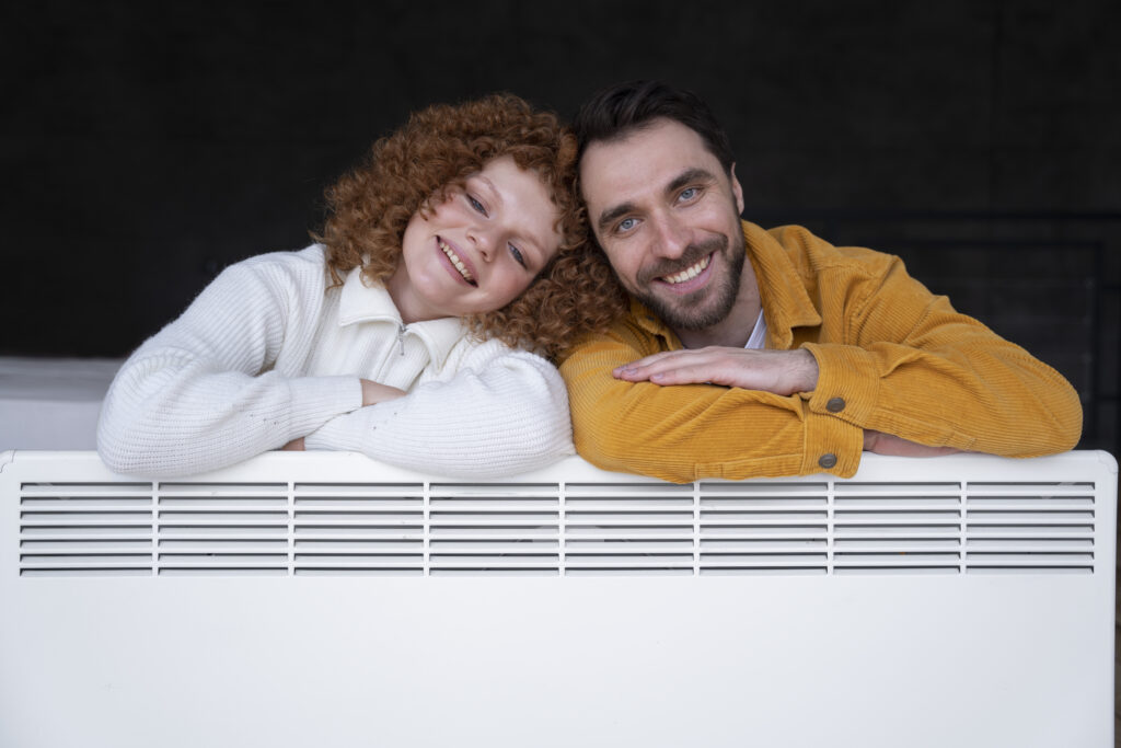 medium shot smiley couple with heater