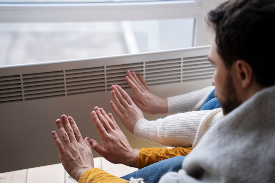 people warming up their hands with heater
