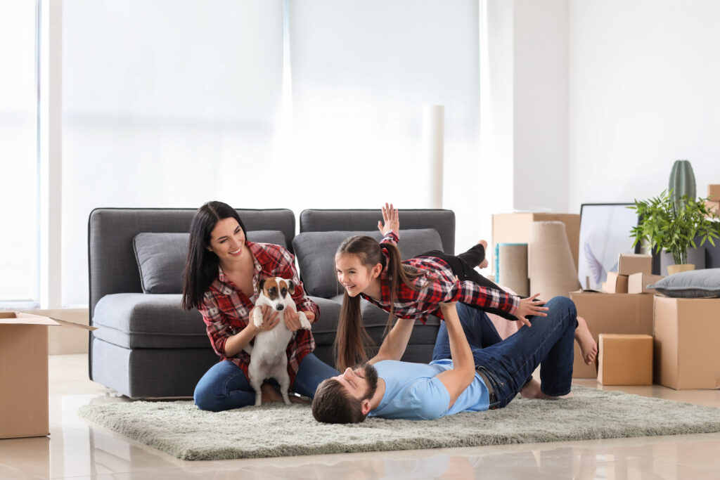 Happy family playing after moving into new house