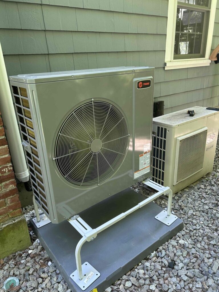 HVAC & Plumbing in Dover, MA 13 Trane 3 ton heat pump on a stand beside a Dover, MA home