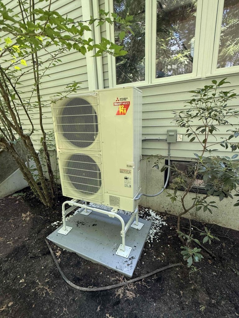 HVAC & Plumbing in Franklin, MA 11 Mitsubishi four-zone heat pump outdoor unit beside a Franklin, MA colonial
