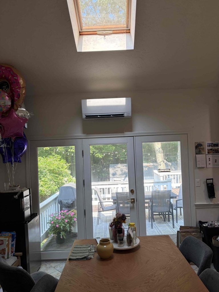 HVAC & Plumbing in Franklin, MA 12 Mitsubishi ductless wall unit above a kitchen patio door in Franklin, MA