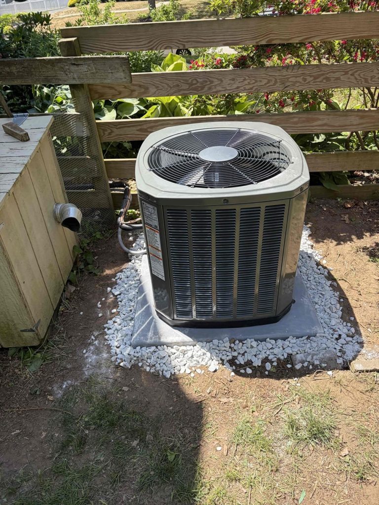 HVAC & Plumbing in Medfield, MA 11 New Trane 2.5 ton AC condenser on a pad beside a Medfield, MA home