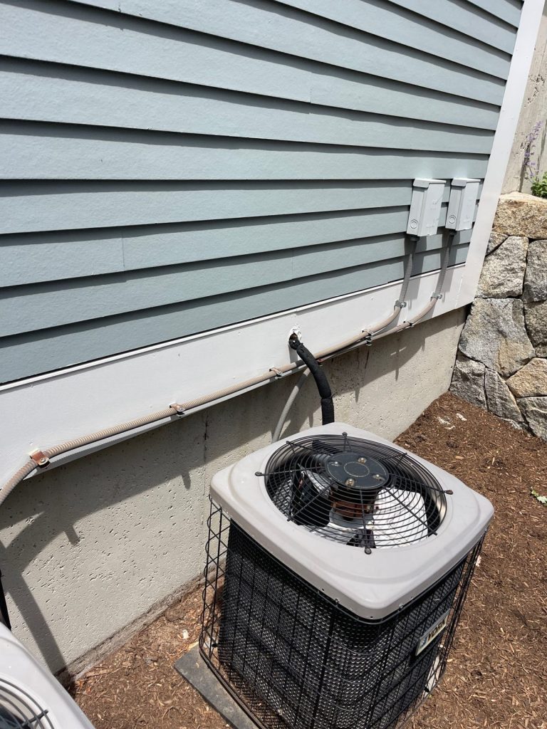 HVAC & Plumbing in Medfield, MA 13 Aging AC condenser at a Medfield, MA home before replacement