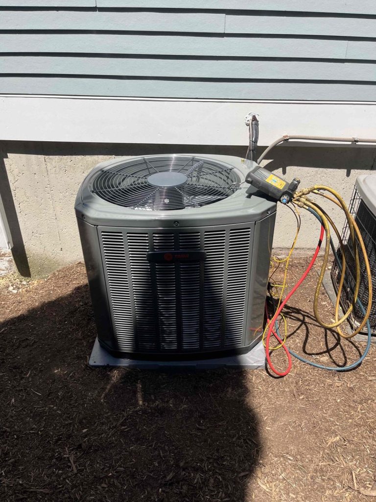 HVAC & Plumbing in Medfield, MA 14 New Trane AC condenser being charged at a Medfield, MA home